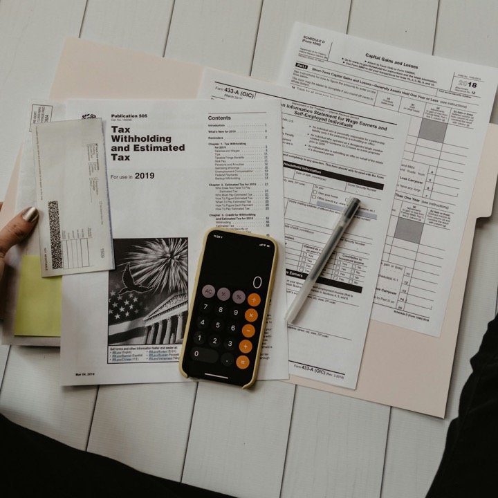 A university scholarship letter and financial planning documents on a desk