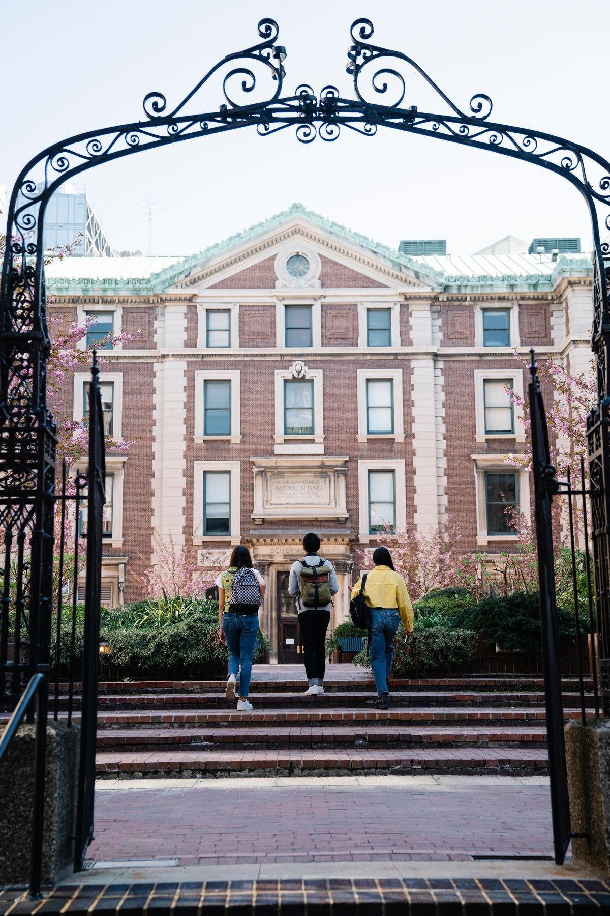 Students walking together toward a university campus